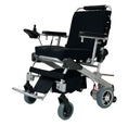 Load image into Gallery viewer, EZ Lite Cruiser Deluxe Regular DX8 electric wheelchair viewed from the front-left angle, showing its unfolded frame and controls.