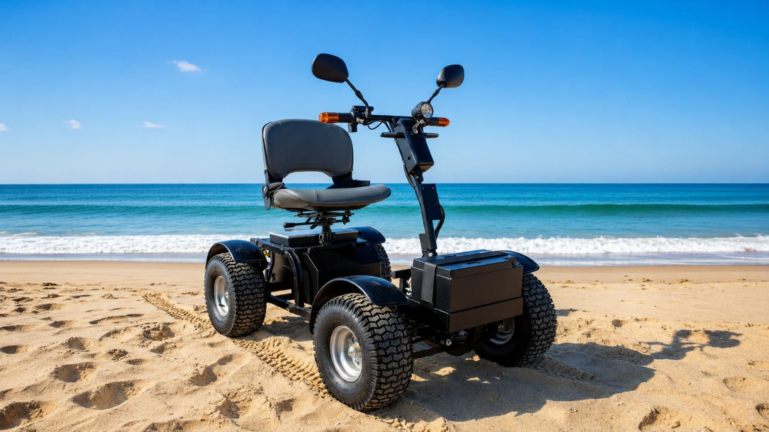 All-terrain mobility scooter on beach sand with large off-road tires