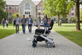 Load image into Gallery viewer, EZ Lite Cruiser Deluxe Regular DX8 electric wheelchair shown unfolded from the left side, highlighting its compact design and frame details.
