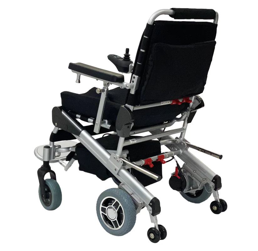 EZ Lite Cruiser Deluxe Regular DX8 electric wheelchair shown unfolded from the back-left angle, highlighting the frame and wheels.
