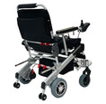 Load image into Gallery viewer, EZ Lite Cruiser Deluxe Regular DX8 electric wheelchair viewed from the back unfolded, showing its sturdy frame and rear wheels.
